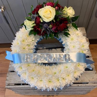 Based wreath with lettered ribbon